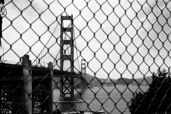 Golden Gate Bridge through a fence
