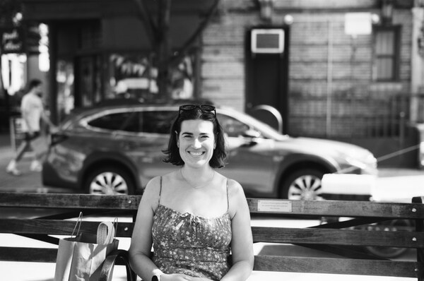 Woman smiling on a park bench